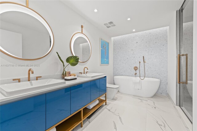 bathroom featuring a washtub and vanity