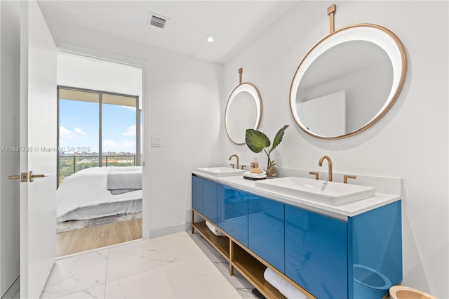 full bathroom with double vanity, visible vents, marble finish floor, and a sink