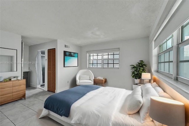 tiled bedroom featuring multiple windows