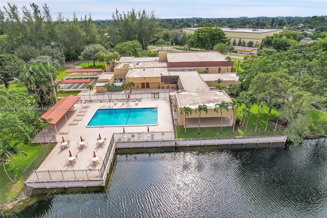 view of pool featuring a patio and a water view