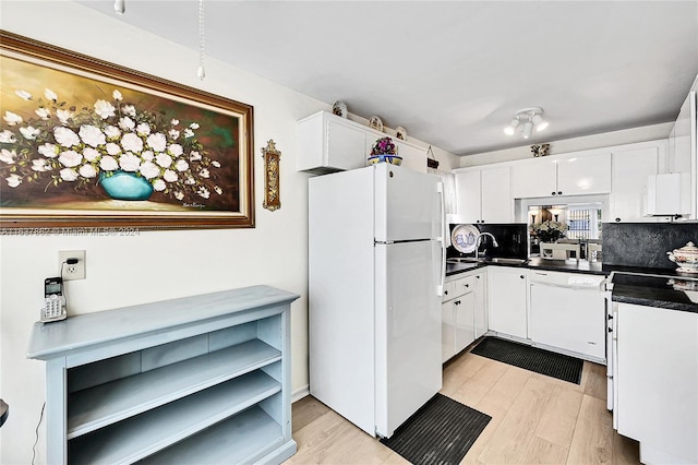 kitchen with white appliances, sink, light wood-type flooring, backsplash, and white cabinetry