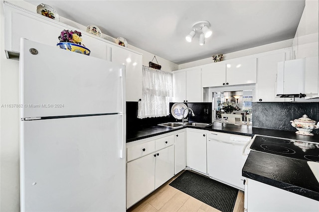 kitchen featuring sink, light wood-type flooring, white cabinetry, white appliances, and tasteful backsplash