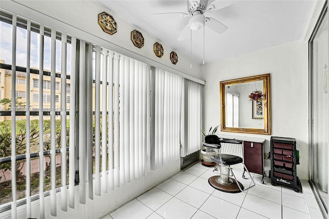 sunroom / solarium featuring ceiling fan