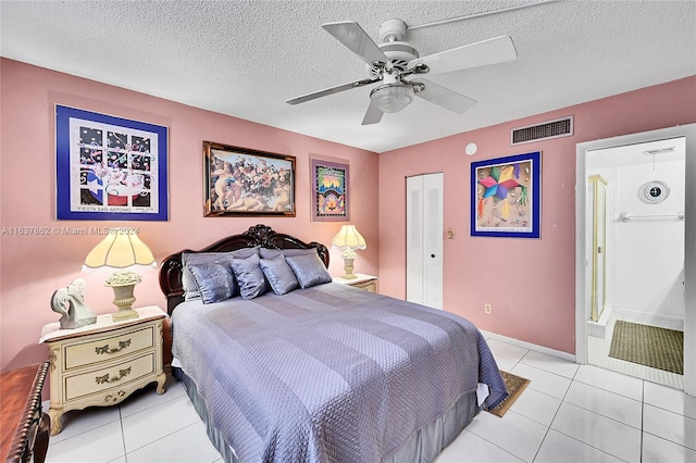 tiled bedroom with a closet, a textured ceiling, and ceiling fan