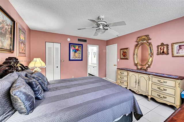 bedroom with ensuite bath, a textured ceiling, a closet, and ceiling fan