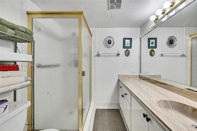 bathroom with toilet, an enclosed shower, vanity, and tile patterned flooring