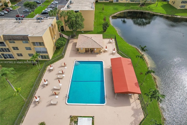 view of swimming pool featuring a patio area and a water view