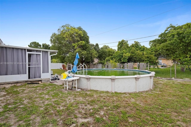 view of yard with a fenced in pool