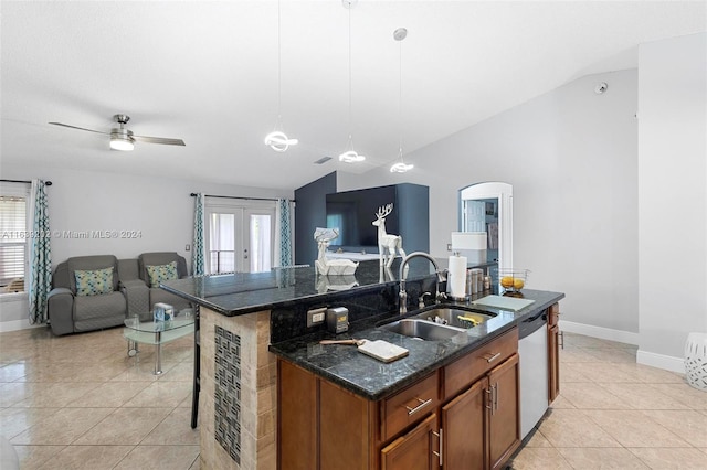 kitchen with a center island with sink, hanging light fixtures, and lofted ceiling