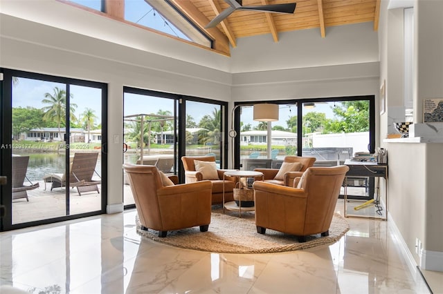 sunroom with a water view, plenty of natural light, vaulted ceiling with beams, and wooden ceiling