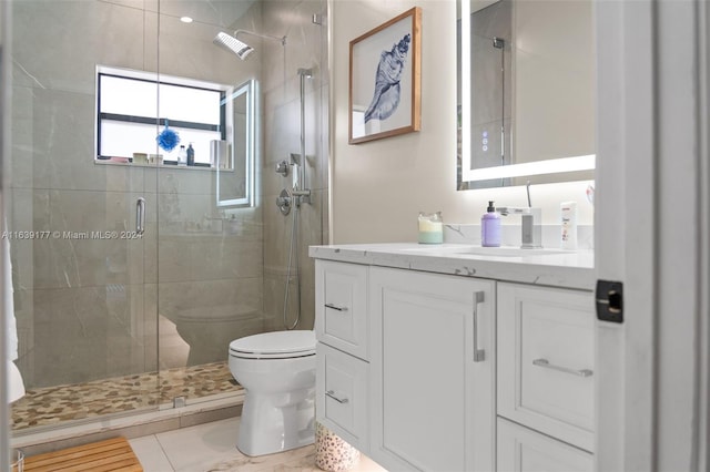 bathroom featuring vanity, toilet, and an enclosed shower