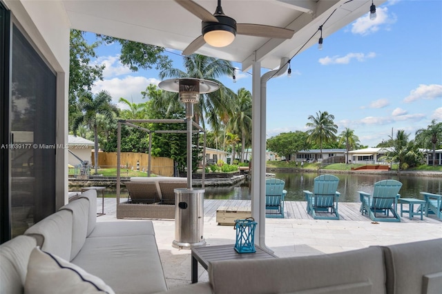 view of patio / terrace with a water view, ceiling fan, and outdoor lounge area