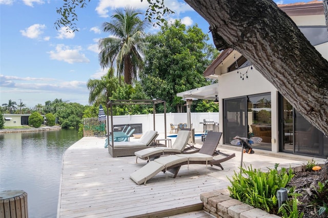 wooden terrace featuring a water view