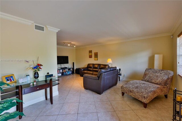 living area featuring light tile patterned floors, ornamental molding, and visible vents