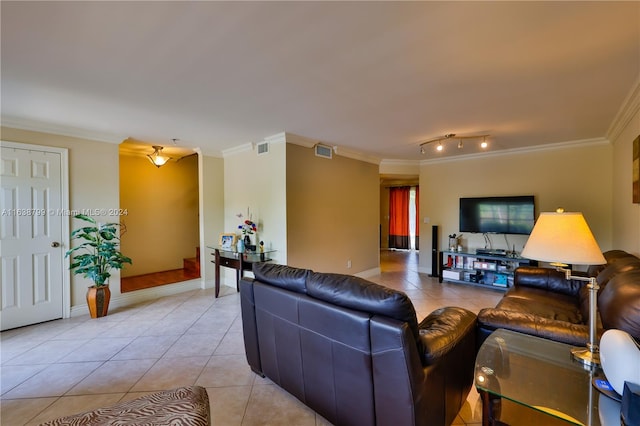 tiled living room with rail lighting and ornamental molding