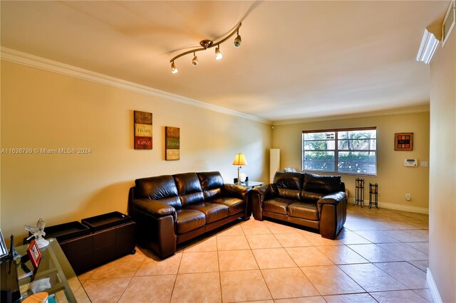 living room with ornamental molding and light tile patterned floors