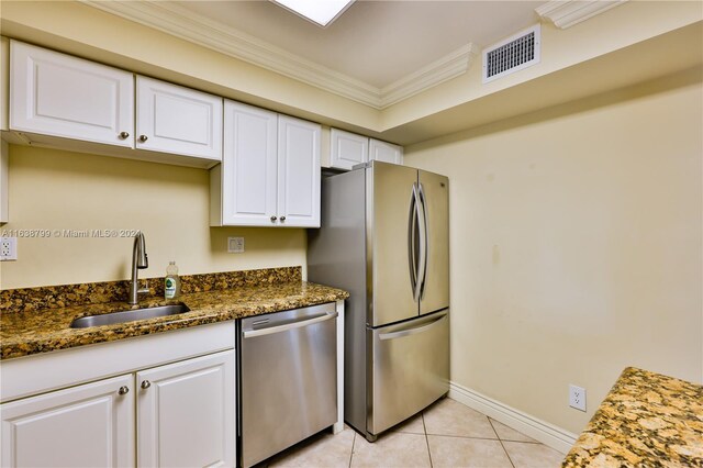 kitchen with sink, stainless steel appliances, dark stone countertops, and white cabinets