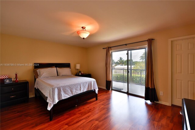 bedroom featuring access to outside and dark hardwood / wood-style floors