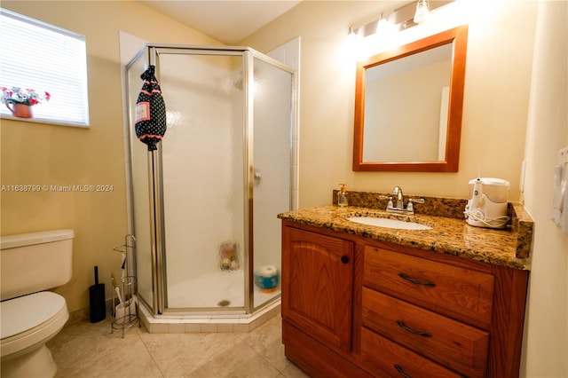 bathroom with an enclosed shower, vanity, tile patterned flooring, and toilet