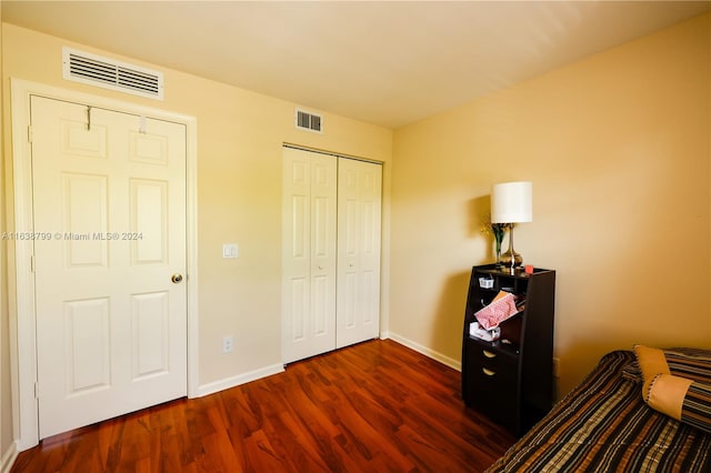 bedroom featuring dark hardwood / wood-style floors and a closet