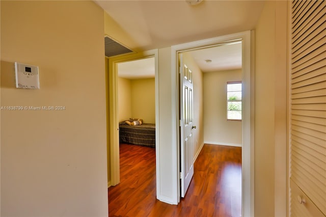 corridor with hardwood / wood-style floors