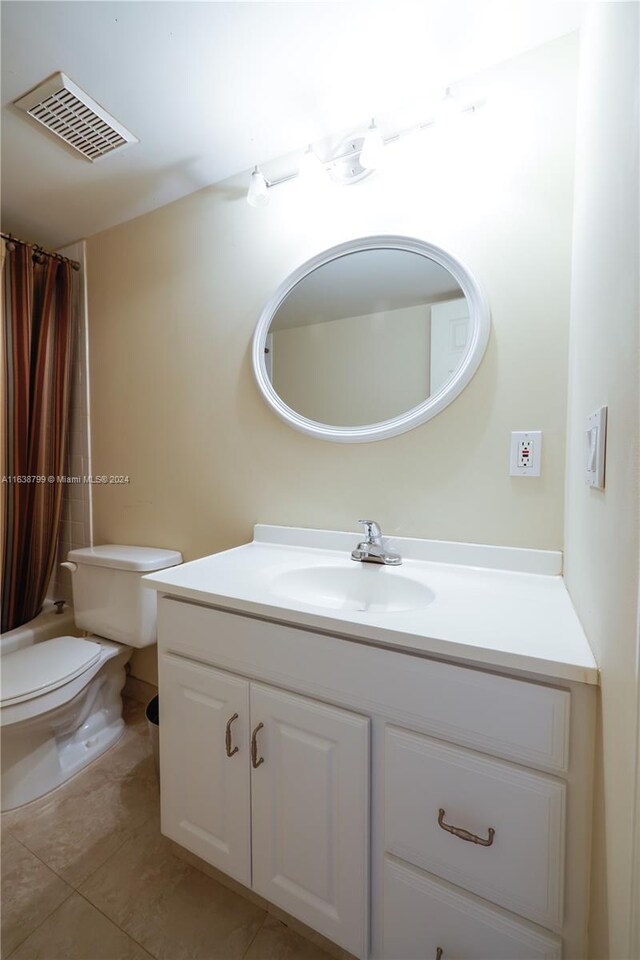 bathroom with tile patterned floors, vanity, and toilet