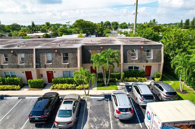 view of building exterior with uncovered parking