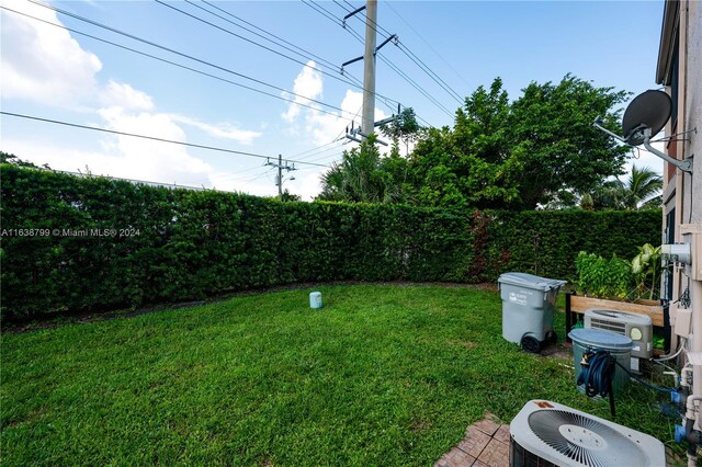 view of yard with cooling unit and fence