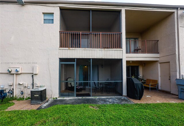 back of house with cooling unit, a patio, a balcony, and stucco siding