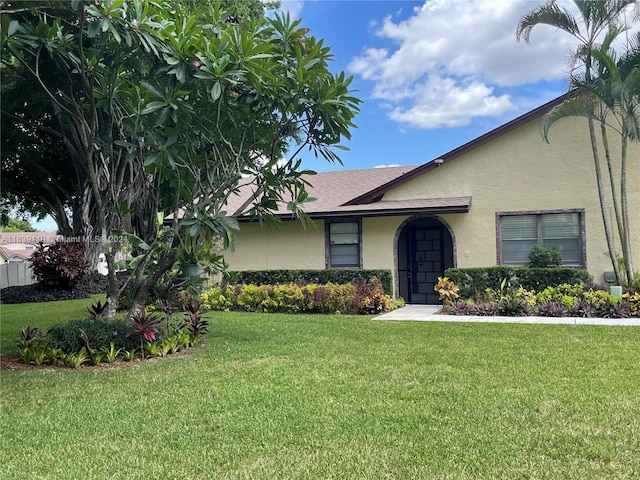 ranch-style home featuring a front yard