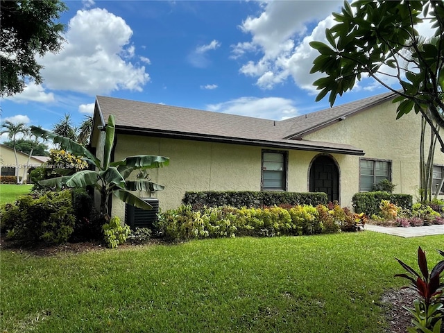 view of home's exterior featuring central AC unit and a yard