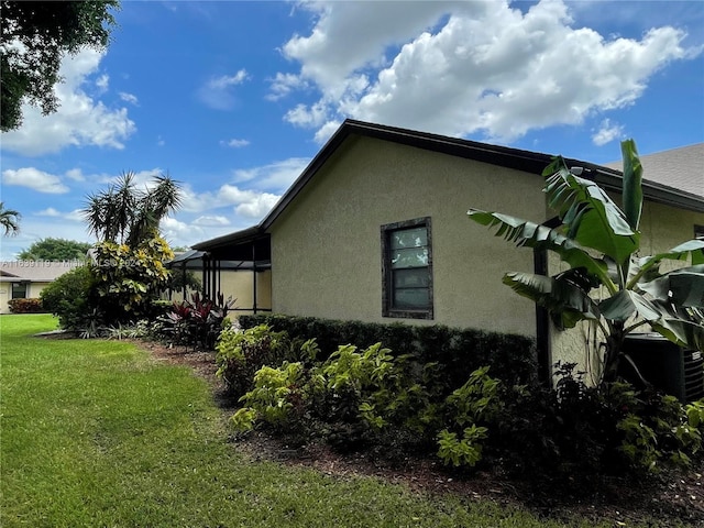 view of side of home featuring a yard