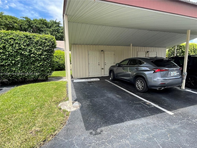 view of parking featuring a carport and a yard