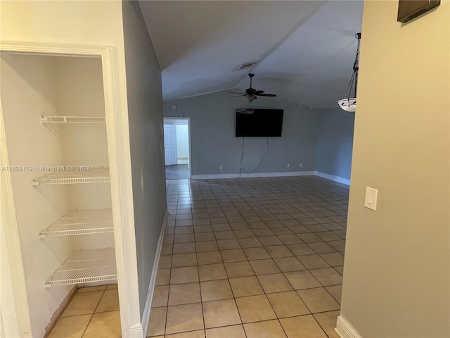 interior space featuring lofted ceiling and ceiling fan