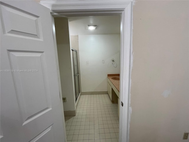 bathroom with walk in shower, tile patterned floors, and vanity