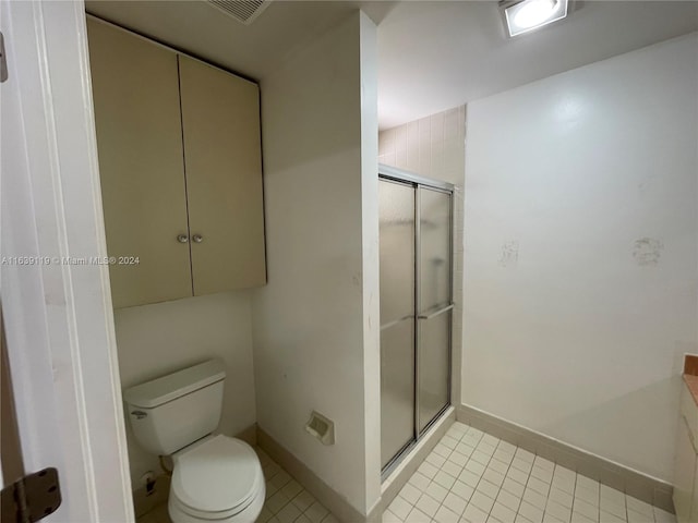 bathroom with a shower with door, toilet, tile patterned floors, and vanity