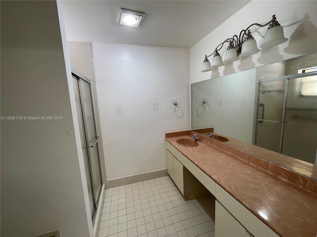 bathroom featuring vanity, walk in shower, and tile patterned flooring