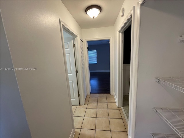 hall with light tile patterned floors