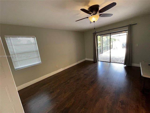 spare room featuring ceiling fan and dark hardwood / wood-style flooring