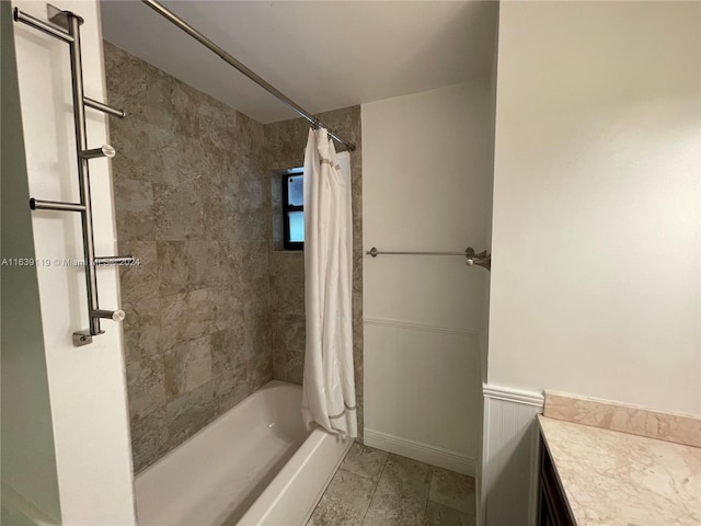 bathroom with shower / tub combo with curtain, tile patterned floors, and vanity