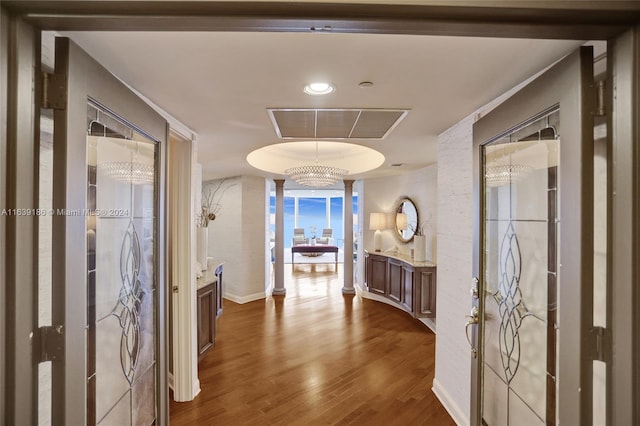 corridor featuring hardwood / wood-style floors and a raised ceiling