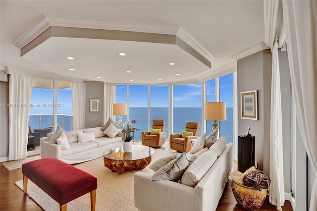 living room featuring a water view, a wall of windows, and hardwood / wood-style flooring