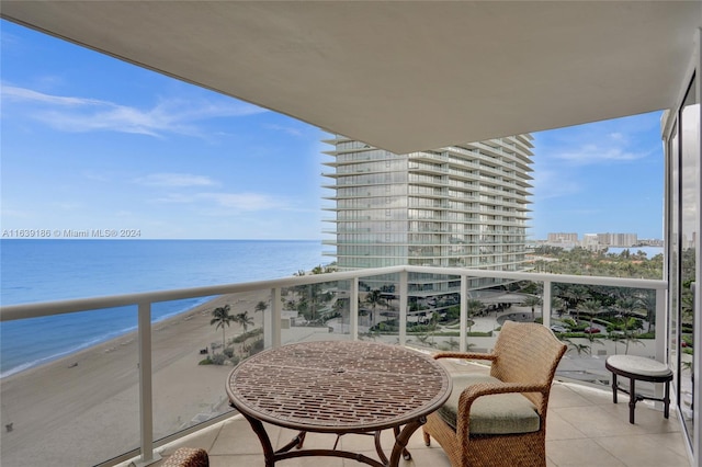 balcony with a water view and a beach view