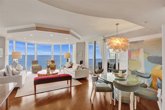 interior space with dark hardwood / wood-style flooring, a water view, expansive windows, and an inviting chandelier