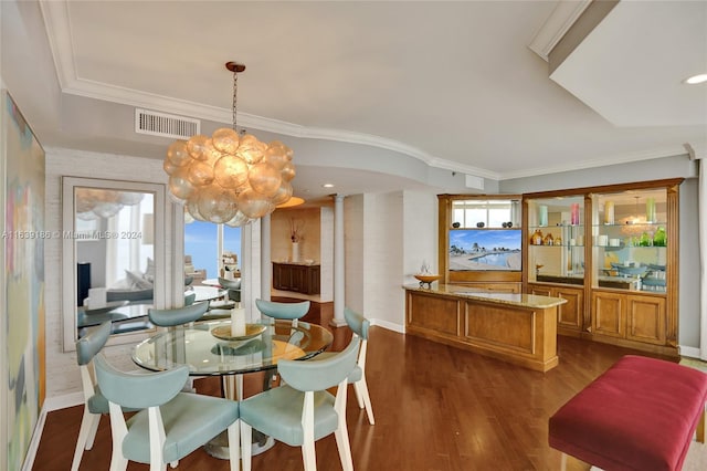 dining area with dark wood-type flooring, plenty of natural light, and ornamental molding