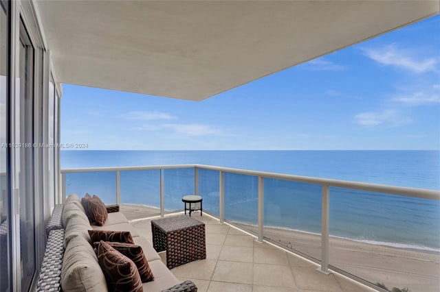 balcony featuring a beach view and a water view