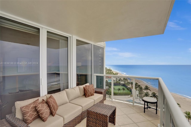 balcony featuring a water view, an outdoor living space, and a beach view