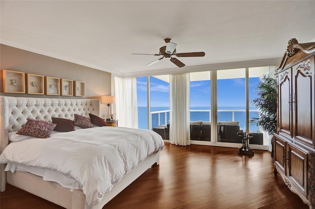 bedroom with a water view, a wall of windows, crown molding, dark hardwood / wood-style flooring, and ceiling fan