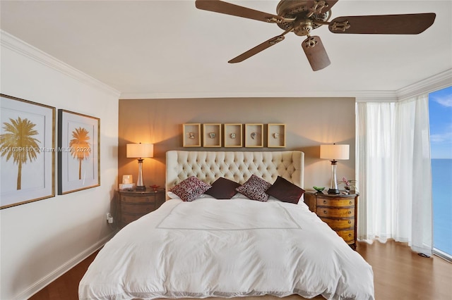 bedroom with ornamental molding, ceiling fan, and dark hardwood / wood-style floors