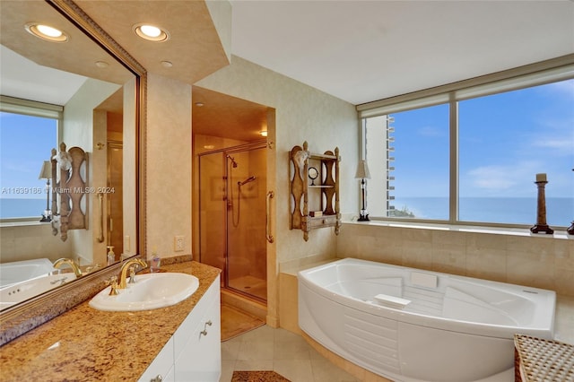 bathroom featuring vanity, a water view, separate shower and tub, and tile patterned floors